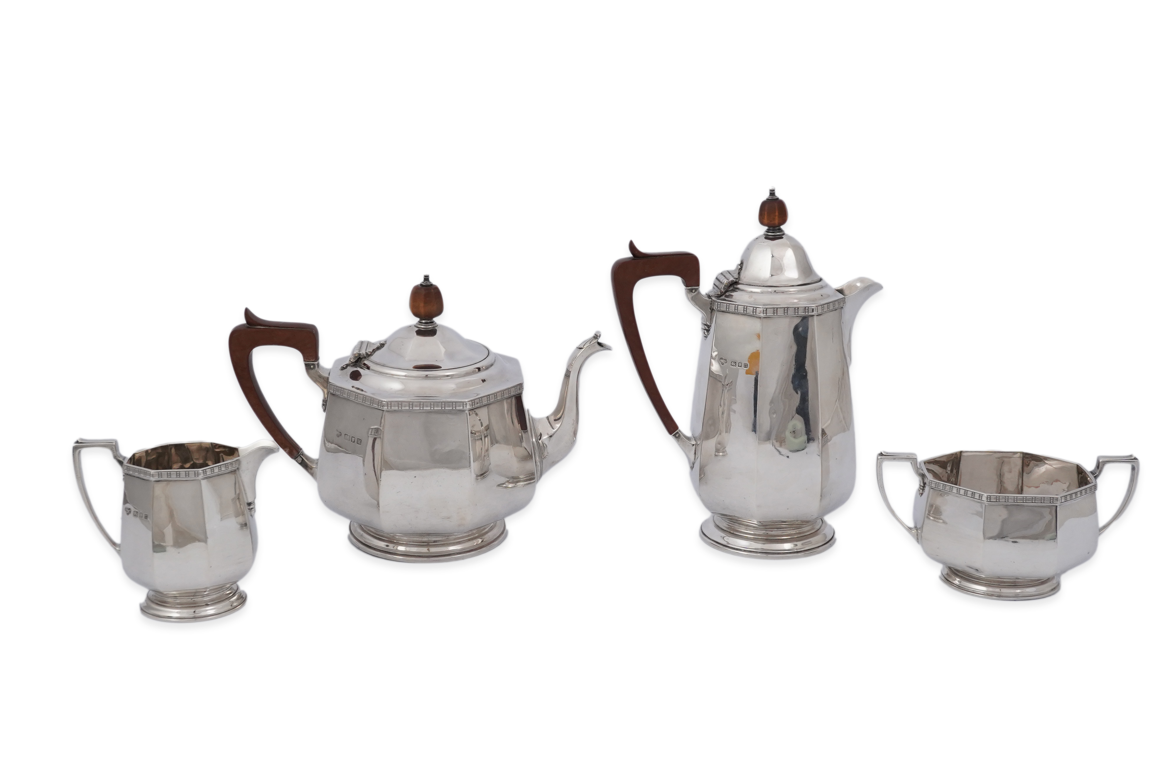 A George V silver four piece octagonal tea set by Goldsmiths & Silversmiths Co Ltd